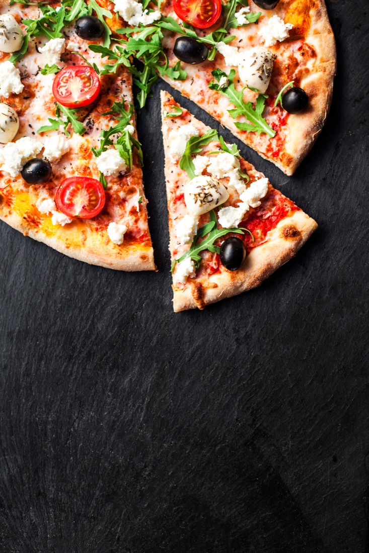 Image of a pizza on black background