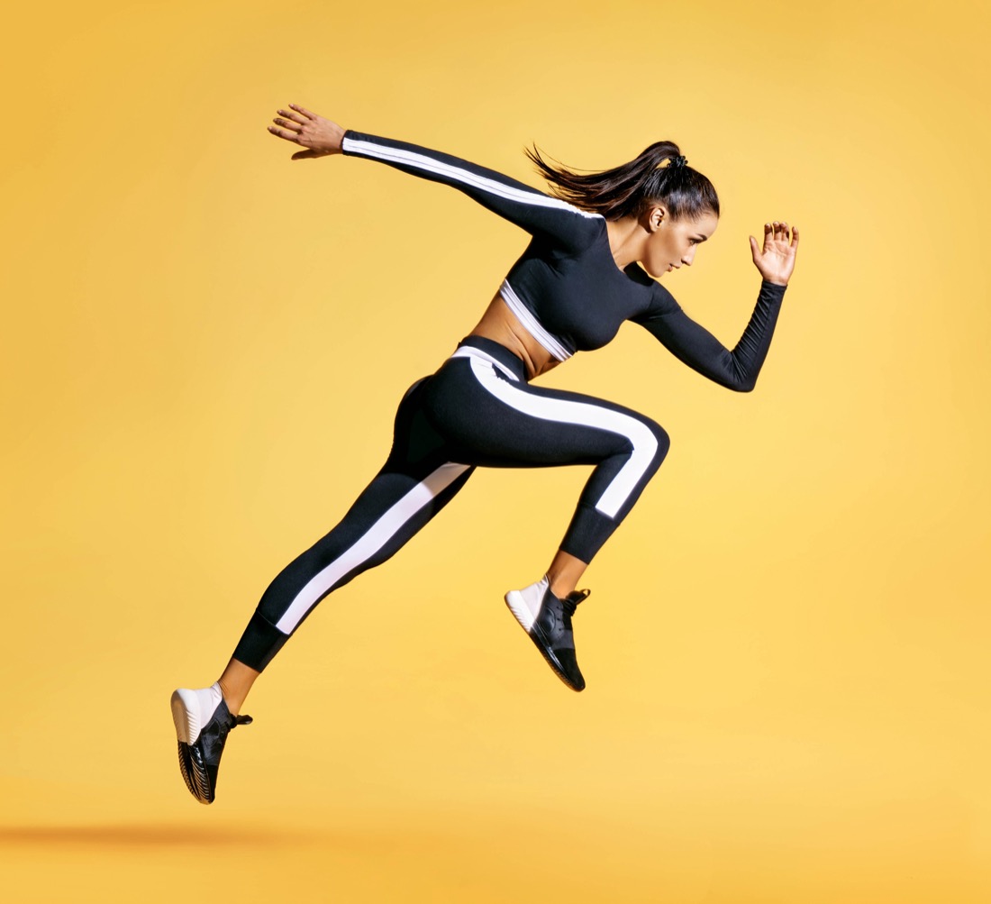 Woman running yellow background