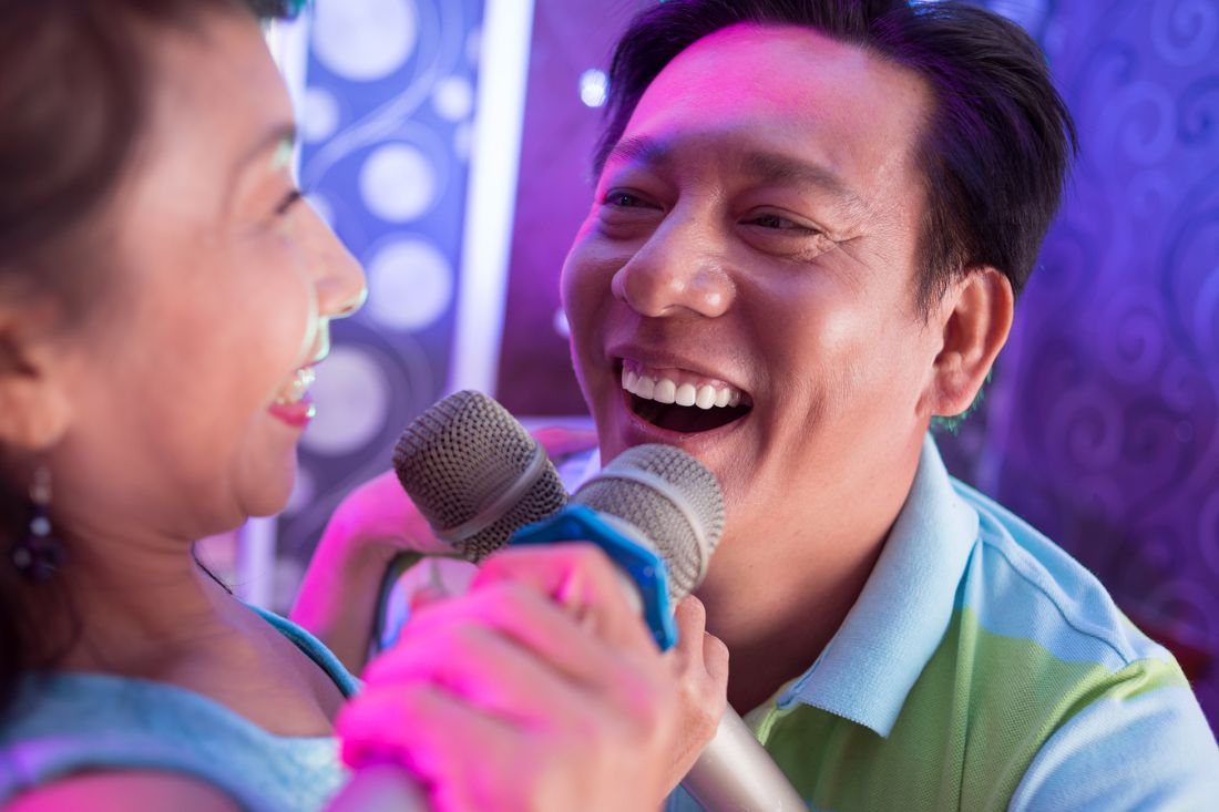 Asian man singing a duet.