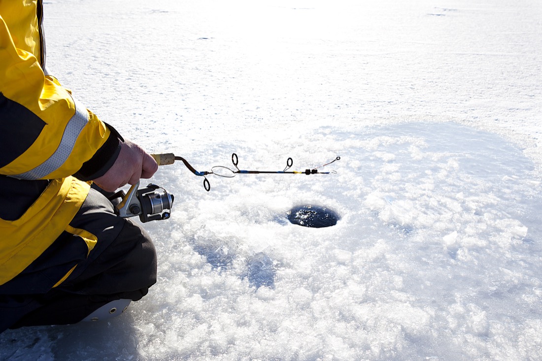 Ice Fishing in Frozen Lake